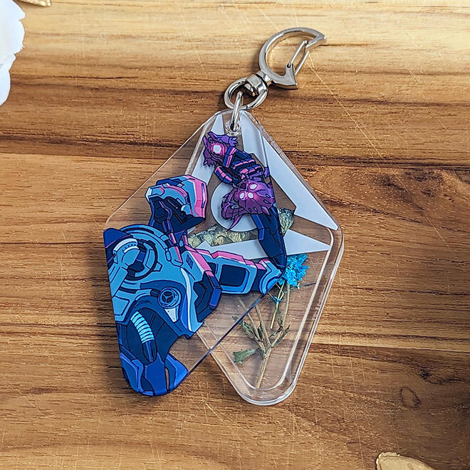 Acrylic charm with dried flowers inside. Design based on DOOM Eternal.